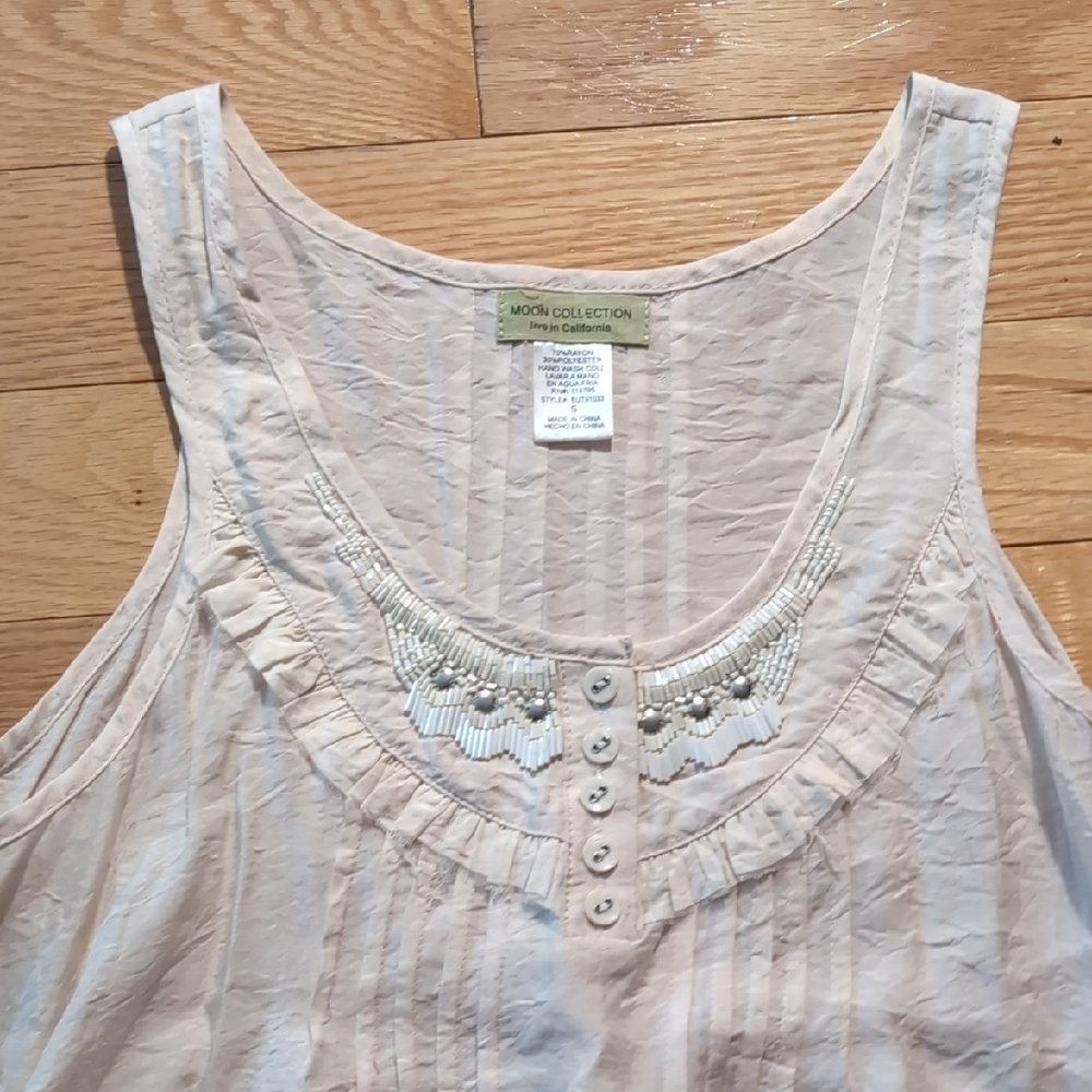Sleeveless Ruffle Blouse with Asymmetrical Hem